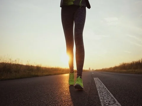 Unrecognizable Woman Running on Country Road at Sunrise. STABILIZED SLOW MOTION Stock Footage