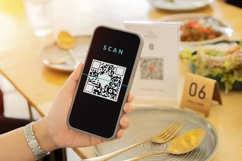 Unrecognizable woman scanning Qr Code for online payment or check menu at a.. Stock-Fotos