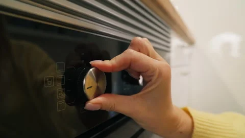Unrecognizable woman turning  temperature knob and choose cook program on m.. Stock Footage 327161853