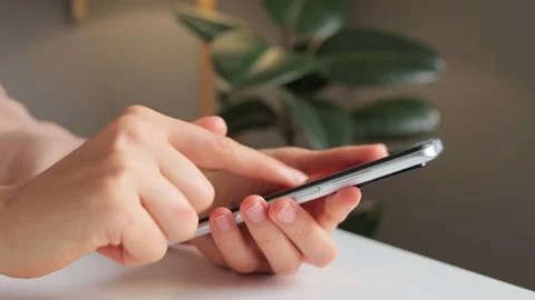 Unrecognizable woman using modern smartphone female hands holding cellphone Stock Footage 253886992