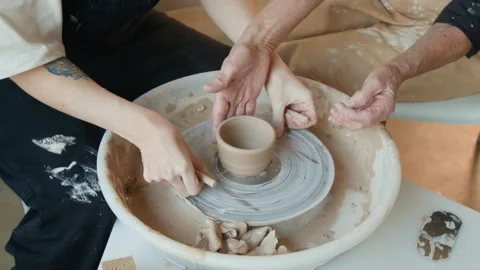 Unrecognizable Women Using Thread on Bottom of Ceramic Piece on Potters wheel Stock Footage 331806068