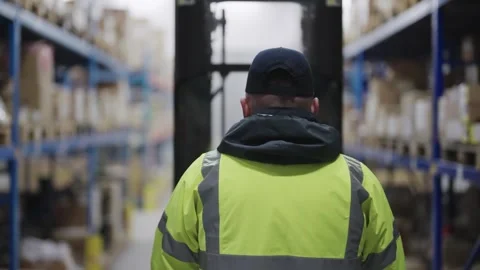 Unrecognizable worker operating a forklift in a large organized warehouse Stock-Footage 331891207