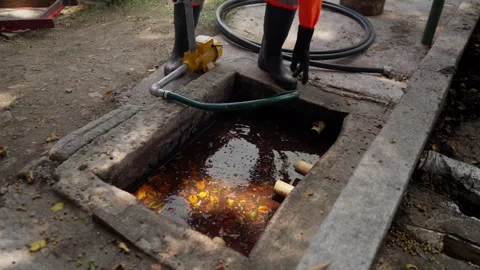 Unrecognizable Worker Pumps Organic Waste Slurry for BioCiclo Project Stock Footage 346611171