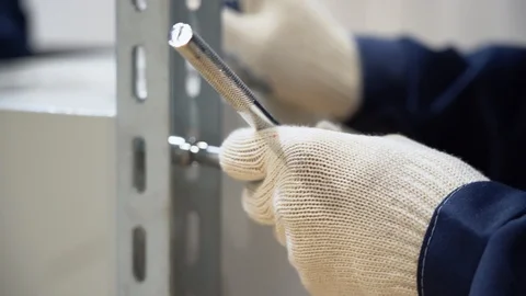 Unrecognizable worker screwing metal rack to standing gray box close up Stock Footage 126356295