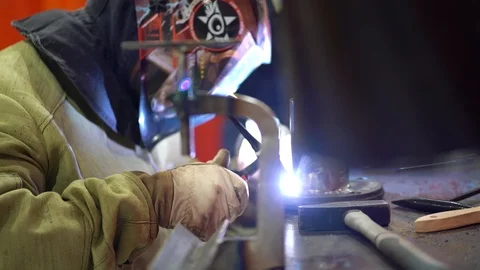 Unrecognizable worker use gas machine, makes spot welding of metal parts  Stock Footage 126357336