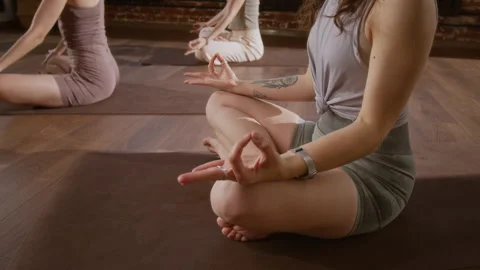 Unrecognizable Yoga Devotees Practicing Pranayama Breathing in Studio Stock Footage 329743083