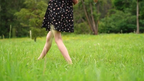 Unrecognizable young child walking on the grass barefoot. enjoying one s life. Stock Footage 210226048