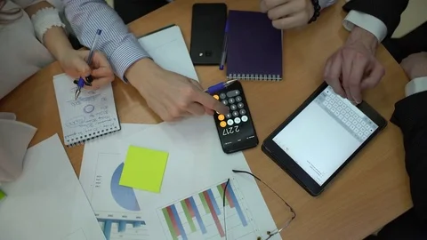 Unrecognizable young creative startup team having a progress meeting looking at Stock Footage 85056160