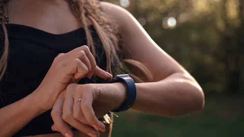 Unrecognizable young girl using her fitness tracker before park workout Stock Footage 91655215