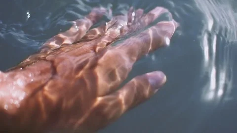 Unrecognizable young man caressing water with soft hands Video stock 82472162