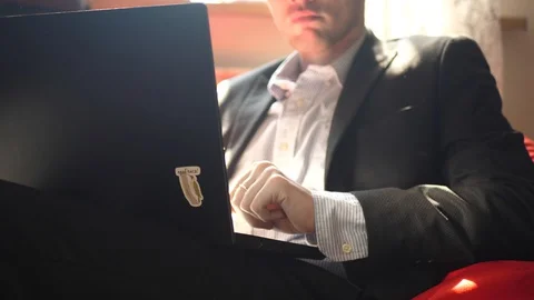 Unrecognizable young man in costume working on a laptop at home Stock-Footage 128442333