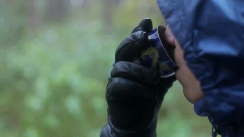 Unrecognizable young man drinks tea in the forest Stock Footage 82196113