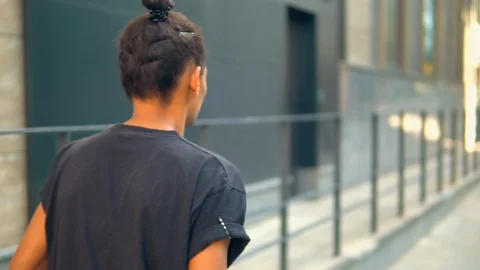 Unrecognizable young man going on the street Stock Footage 127868552