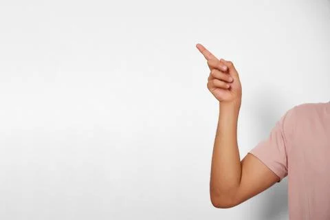 Unrecognizable young man pointing his finger at copy space Stock Photos