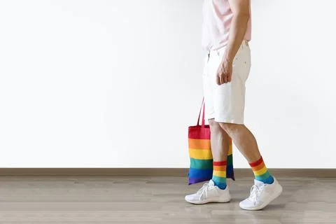 Unrecognizable young man posing dressed in socks and rainbow bag. Concept of Stock Photos