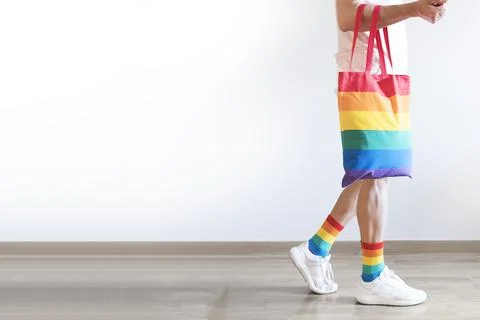 Unrecognizable young man posing dressed in socks and rainbow bag. Concept of Stock Photos