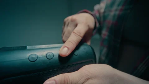 Unrecognizable Young Man Turning On Portable Speaker in Slow Motion Stock Footage 335688869