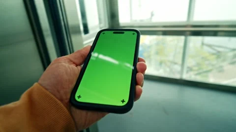 Unrecognizable Young Man Using Smartphone With Green Screen Entering Elevator Video stock 326173491