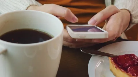 Unrecognizable Young Woman using Cellphone in a Cafe, Close Up on Hands. 4K. Stock Footage 67222905