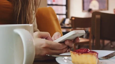 Unrecognizable Young Woman using Cellphone in a Cafe, Close Up on Hands. 4K. Stock Footage 67222992