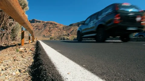 Unrecognized black off-road crossover car rides along a mountain asphalt road in Stock Footage 119763320