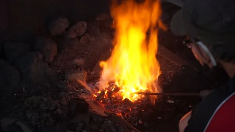 Unrecognized Blacksmith Holding Metal Over Burning Coals. Stock Footage 149028650