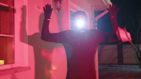 Unrecognized man in balaclava counting stolen money outdoors Stock Footage 237281157