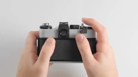 An unrecognized man presses the shutter button on an old, vintage, retro photo Stock Footage 121164228