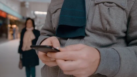 Unrecognized Man with a wedding ring uses a smartphone. Slow Motion Close-up Stock Footage 107358521