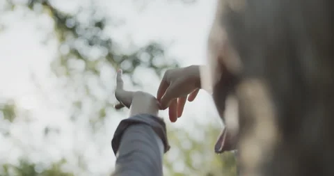 Unrecognized model puts her hands up in the air and moves her fingers Stock Footage 137032518