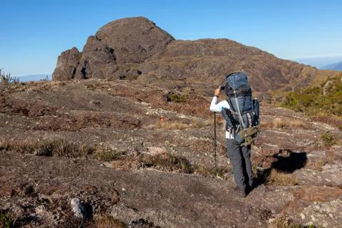 Unrecognized people using a celular smartphone in a mountain landscape Stock Photos