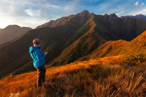 Unrecognized people using a celular smartphone in a mountain landscape Stock Photos