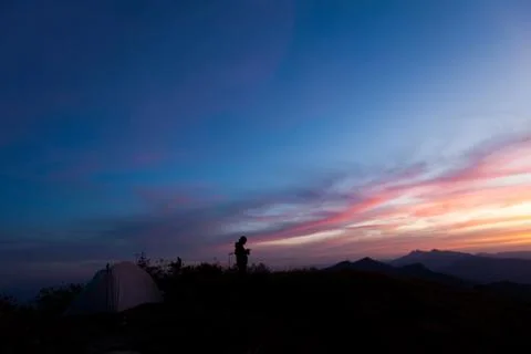 Unrecognized people using a celular smartphone in a mountain landscape Stock Photos