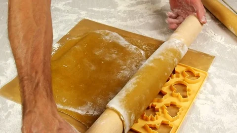 Unroll dough on cutting sheet. Roll dough until pieces are cut off. Stock Footage 77226196