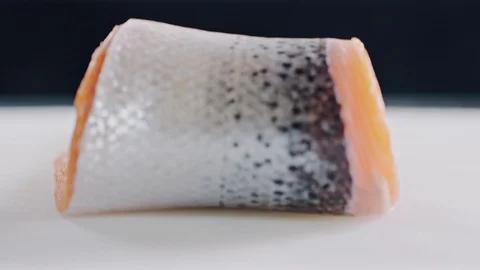 Unrolling nice big slice of red salmon fish Stock Footage 104719947