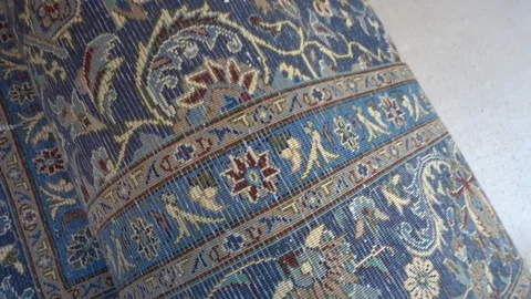Unrolling oriental rug room Stock Footage
