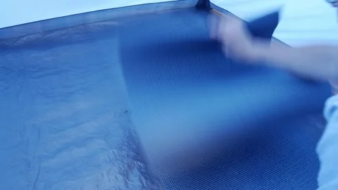 Unrolling Sleeping Pad on Tent Floor for Camping Setup or Outdoor Preparation Stock Footage 336482398