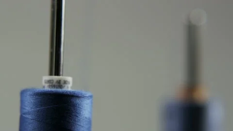 Unrolling a Spool of Blue Thread. Second Thread Visible Stock Footage 89577712