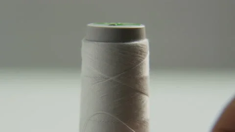 Unrolling a Spool of White Thread Stock Footage 88880510