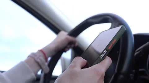 Unsafe driving, using phone while driving. Stock Footage 293345446
