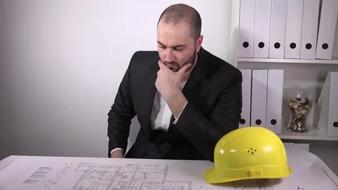 Unsatisfied business architect constructor rubbing chin suspicious blueprints 4K Stock Footage 72900495