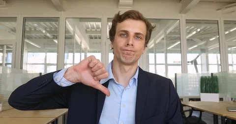 Unsatisfied man with thumbs down indoor Stock Footage 89722022