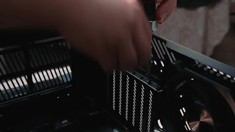 Unscrewing back panel screws of computer case before build Stock Footage 325804216
