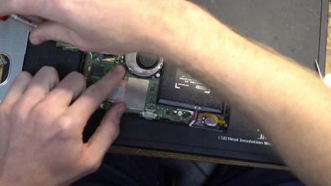 Unscrewing Nintendo Switch Over Head Shot Stock Footage 244281610