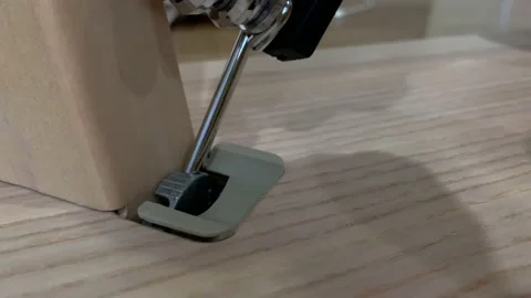 Unscrewing nut using tool and hand from wooden table base. Home appliance Video stock 232096703