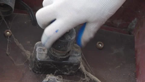 Unscrewing an old automatic electrical plug Stock Footage 315436244