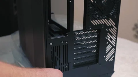 Unscrewing side panel screw of computer case by hand Stock Footage 324591874