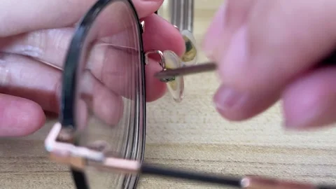 Unscrewing Tiny Screw From Eyeglasses Nose Pads For Home DIY Stock Footage 332751963