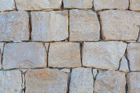 Unshaped stone wall pattern ,wall made of rocks . Stock Photos