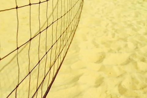 Unsharp volleyball grid against background of sand Stock Photos